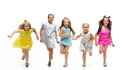 Image showing Happy little caucasian kids jumping and running isolated on white background