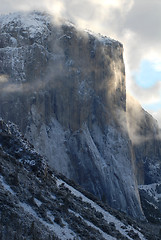 Image showing El Capitan illuminated by early morning stormy skies