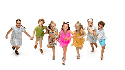 Image showing Happy little caucasian kids jumping and running isolated on white background