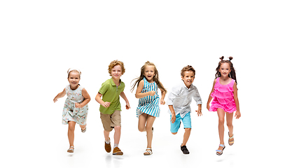 Image showing Happy little caucasian kids jumping and running isolated on white background