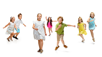 Image showing Happy little caucasian kids jumping and running isolated on white background