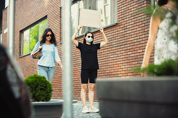 Image showing Dude with sign - woman stands protesting things that annoy her