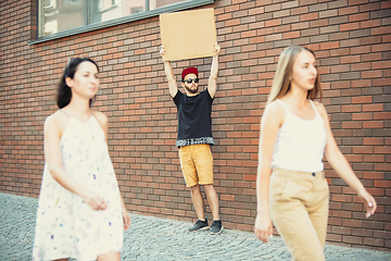 Image showing Dude with sign - man stands protesting things that annoy him