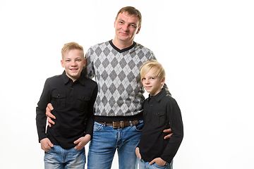 Image showing Half-length portrait of a father and two sons in casual clothes, isolated on a white background