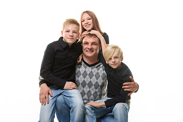 Image showing Half-length portrait of a father and three children in casual clothes on a white background