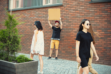 Image showing Dude with sign - man stands protesting things that annoy him