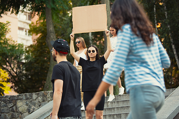 Image showing Dude with sign - woman stands protesting things that annoy her