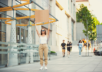 Image showing Dude with sign - woman stands protesting things that annoy her