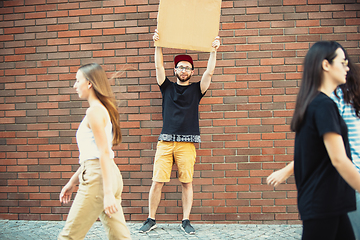 Image showing Dude with sign - man stands protesting things that annoy him