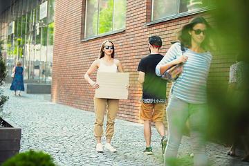 Image showing Dude with sign - woman stands protesting things that annoy her