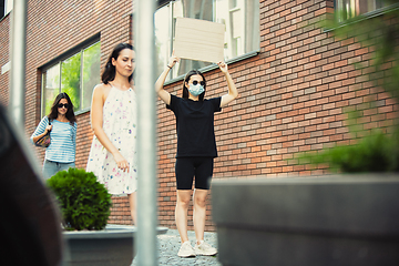 Image showing Dude with sign - woman stands protesting things that annoy her