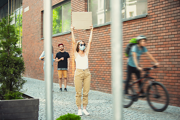 Image showing Dude with sign - woman stands protesting things that annoy her