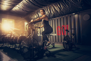 Image showing The female athlete training hard in the gym. Fitness and healthy life concept.