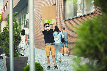 Image showing Dude with sign - man stands protesting things that annoy him