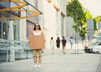 Image showing Dude with sign - woman stands protesting things that annoy her