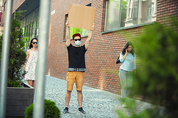 Image showing Dude with sign - man stands protesting things that annoy him