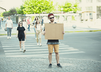 Image showing Dude with sign - man stands protesting things that annoy him