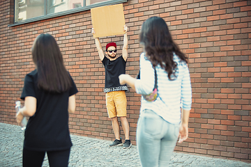 Image showing Dude with sign - man stands protesting things that annoy him