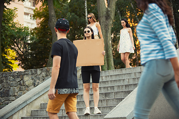 Image showing Dude with sign - woman stands protesting things that annoy her