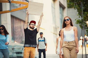 Image showing Dude with sign - man stands protesting things that annoy him