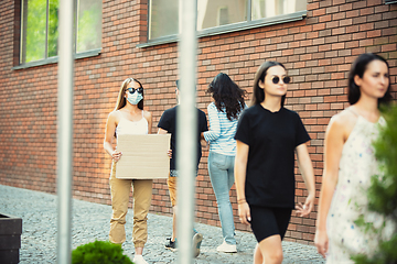 Image showing Dude with sign - woman stands protesting things that annoy her