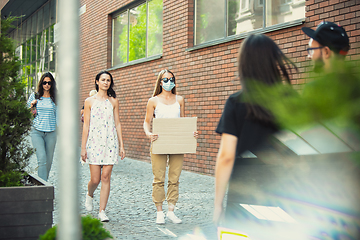 Image showing Dude with sign - woman stands protesting things that annoy her