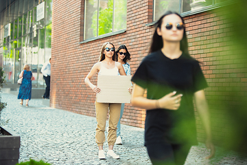 Image showing Dude with sign - woman stands protesting things that annoy her