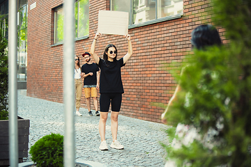 Image showing Dude with sign - woman stands protesting things that annoy her