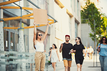 Image showing Dude with sign - woman stands protesting things that annoy her