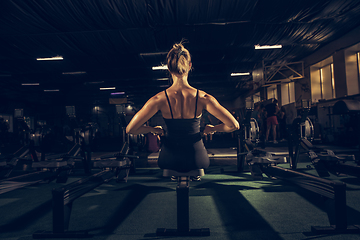 Image showing The female athlete training hard in the gym. Fitness and healthy life concept.