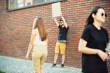 Image showing Dude with sign - man stands protesting things that annoy him