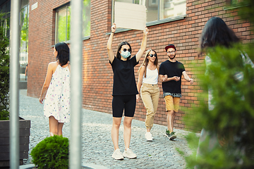 Image showing Dude with sign - woman stands protesting things that annoy her