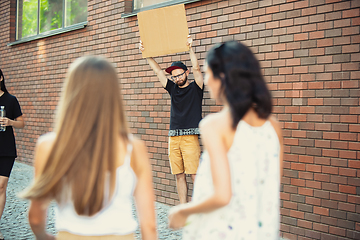 Image showing Dude with sign - man stands protesting things that annoy him