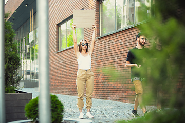 Image showing Dude with sign - woman stands protesting things that annoy her