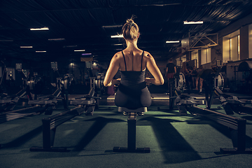 Image showing The female athlete training hard in the gym. Fitness and healthy life concept.
