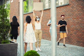 Image showing Dude with sign - woman stands protesting things that annoy her