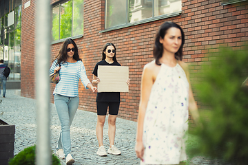 Image showing Dude with sign - woman stands protesting things that annoy her