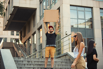 Image showing Dude with sign - man stands protesting things that annoy him