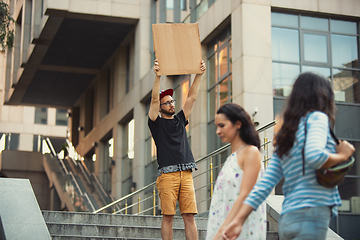 Image showing Dude with sign - man stands protesting things that annoy him