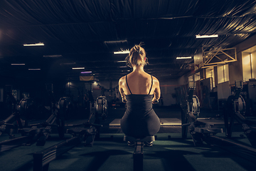 Image showing The female athlete training hard in the gym. Fitness and healthy life concept.