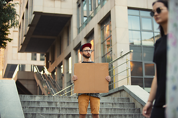 Image showing Dude with sign - man stands protesting things that annoy him