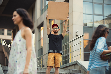 Image showing Dude with sign - man stands protesting things that annoy him