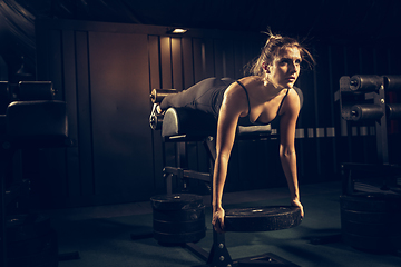 Image showing The female athlete training hard in the gym. Fitness and healthy life concept.