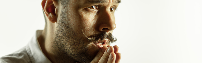 Image showing Caucasian young man\'s close up cropped shot on studio background, flyer