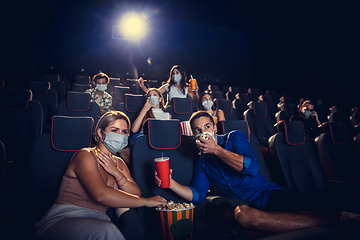 Image showing Cinema, movie theatre during quarantine. Coronavirus pandemic safety rules, social distance during movie watching