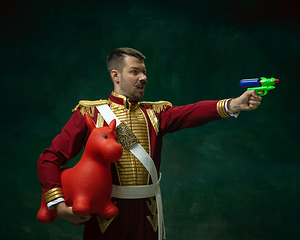 Image showing Young man as Nicholas II on dark green background. Retro style, comparison of eras concept.