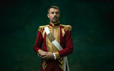 Image showing Young man as Nicholas II on dark green background. Retro style, comparison of eras concept.