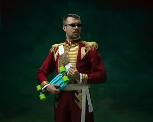 Image showing Young man as Nicholas II on dark green background. Retro style, comparison of eras concept.