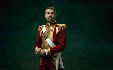 Image showing Young man as Nicholas II on dark green background. Retro style, comparison of eras concept.