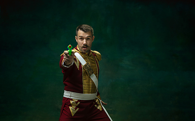 Image showing Young man as Nicholas II on dark green background. Retro style, comparison of eras concept.